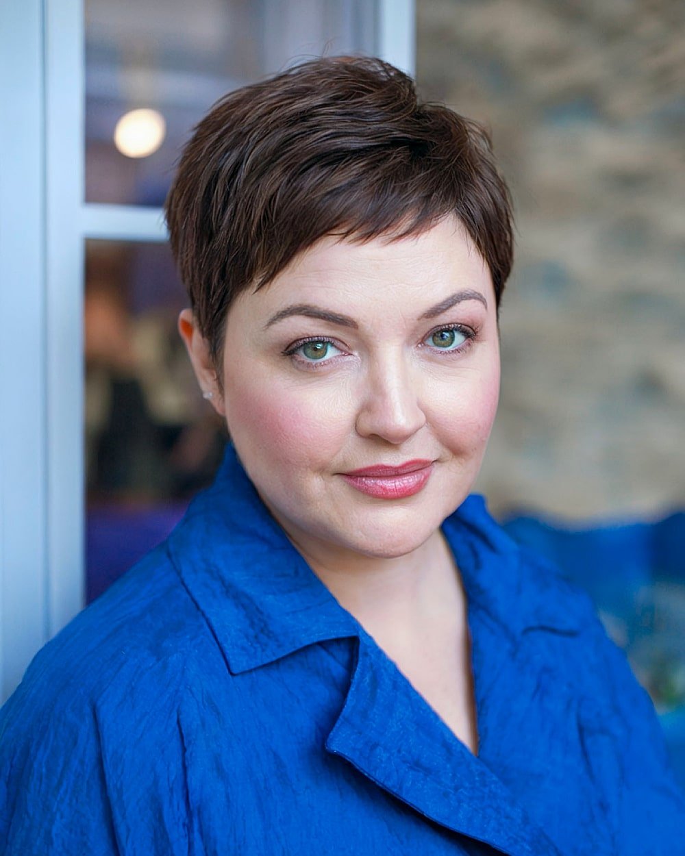 Polished pixie cut with soft texture and side-swept fringe for formal short hair